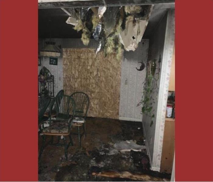 A fire damaged home in Saratoga with soot and debris and the ceiling falling down.