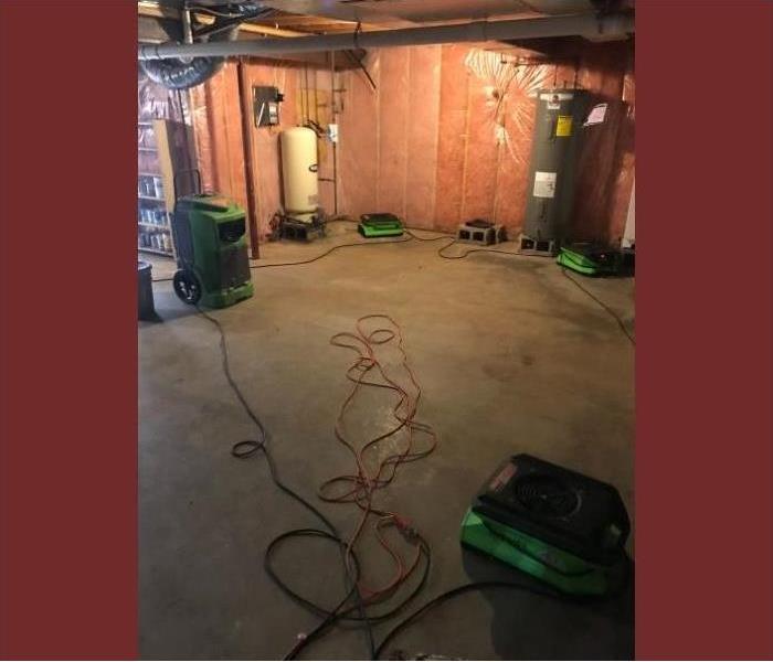 SERVPRO's powerful drying equipment removing the water from the basement.