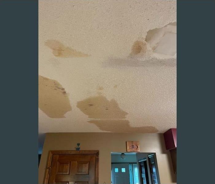 Water stains on the ceiling due to water damage in the room above.