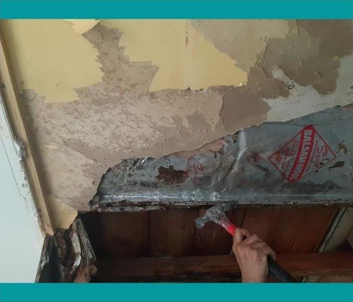 A water damaged ceiling requires removal to get to the damage.