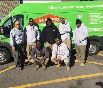 Our crew posing in front of one of our SERVPRO vans.